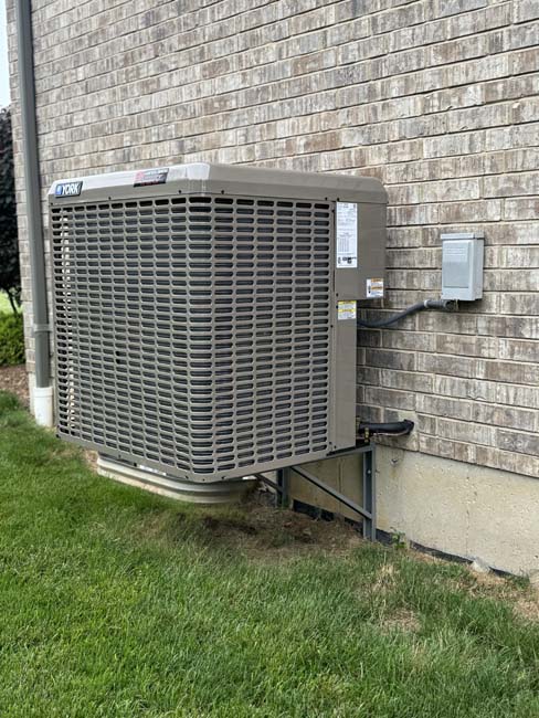 Handy Bros. air conditioning unit installed outside of a customers home, featuring the HB logo.